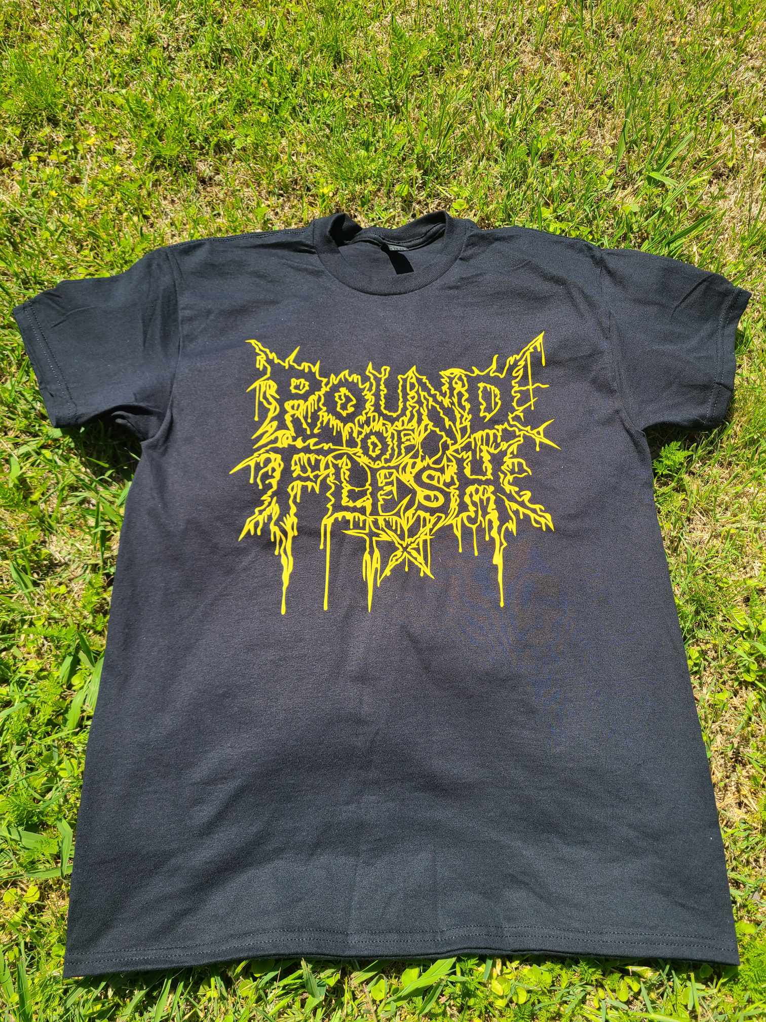 Pound of Flesh TX Yellow Logo on the front of t-shirt